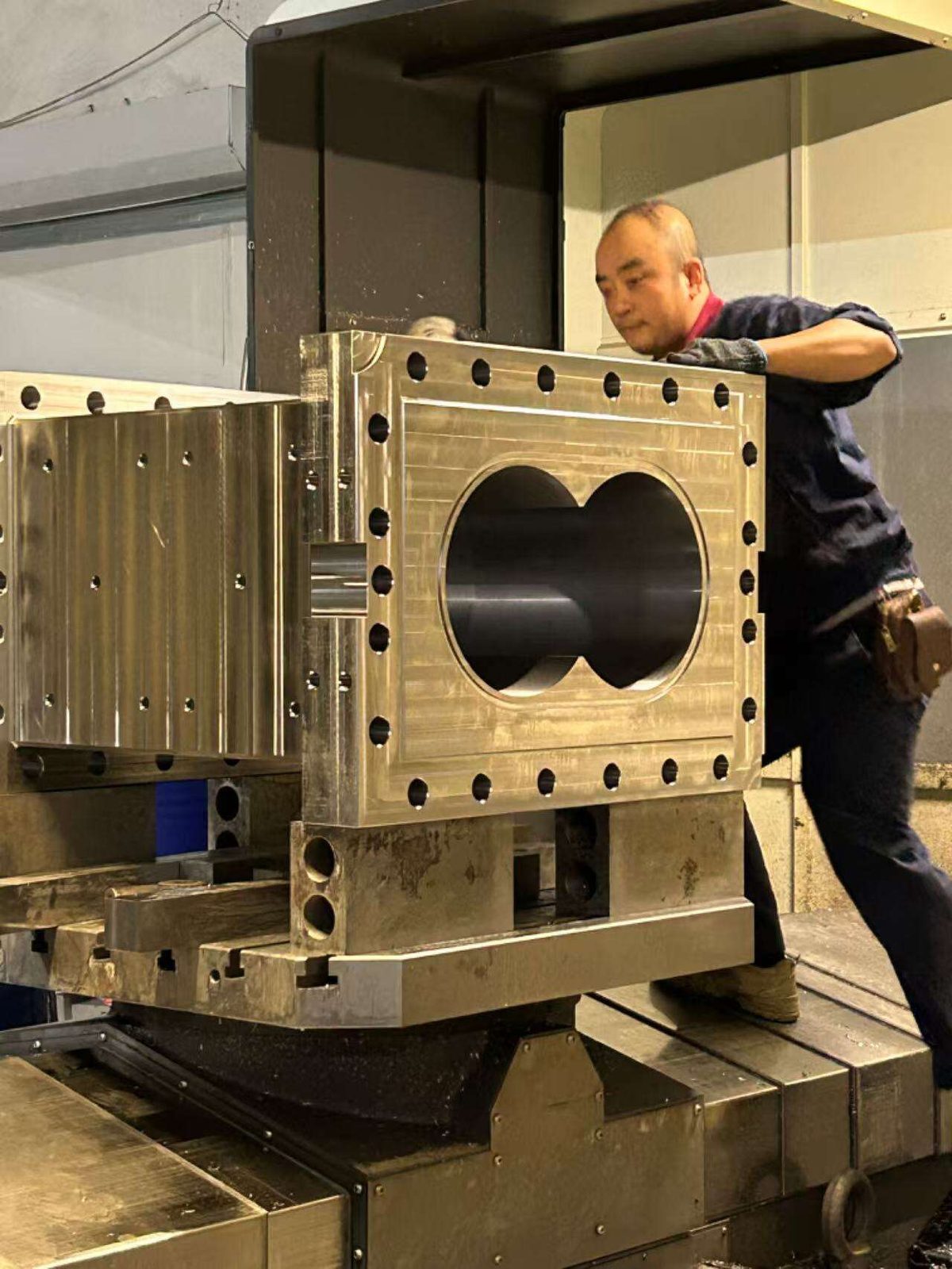 Large twin-screw barrel body being machined on CNC