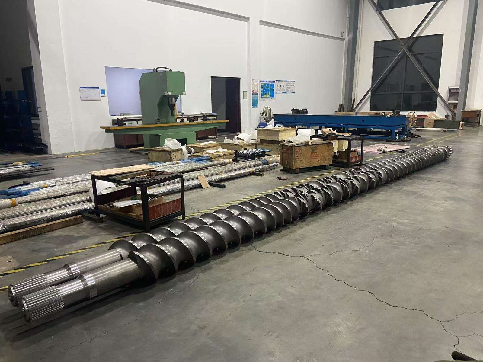 Twin-screw rotor assembly laid out on factory floor for inspection