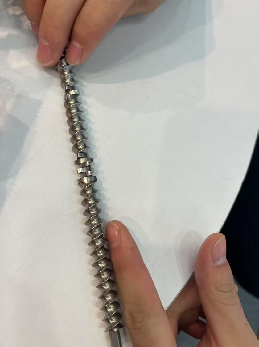 Ground screw shaft with mixing elements being checked by hand